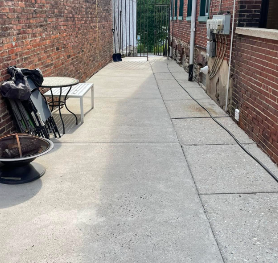 Bright, uniform concrete patio after power washing